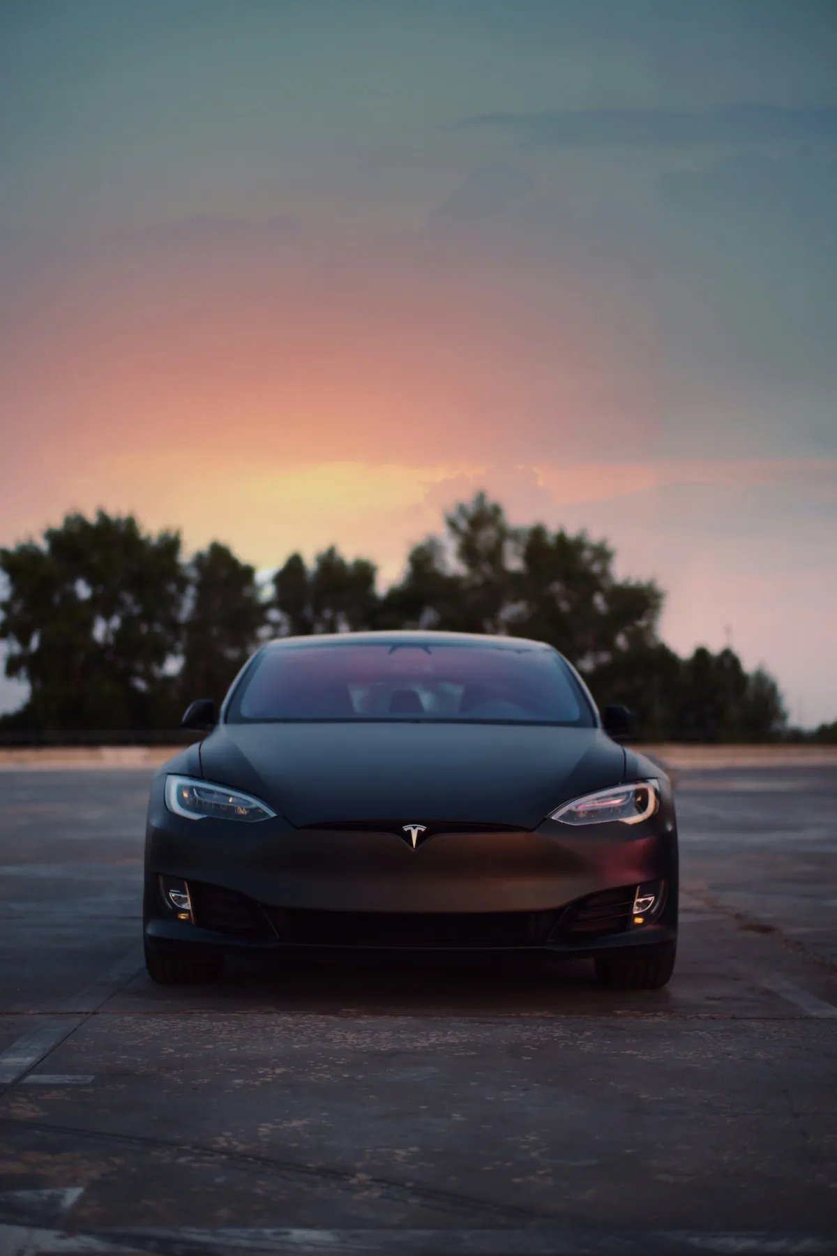 Matte-black Tesla Model S photographed head-on at sunset